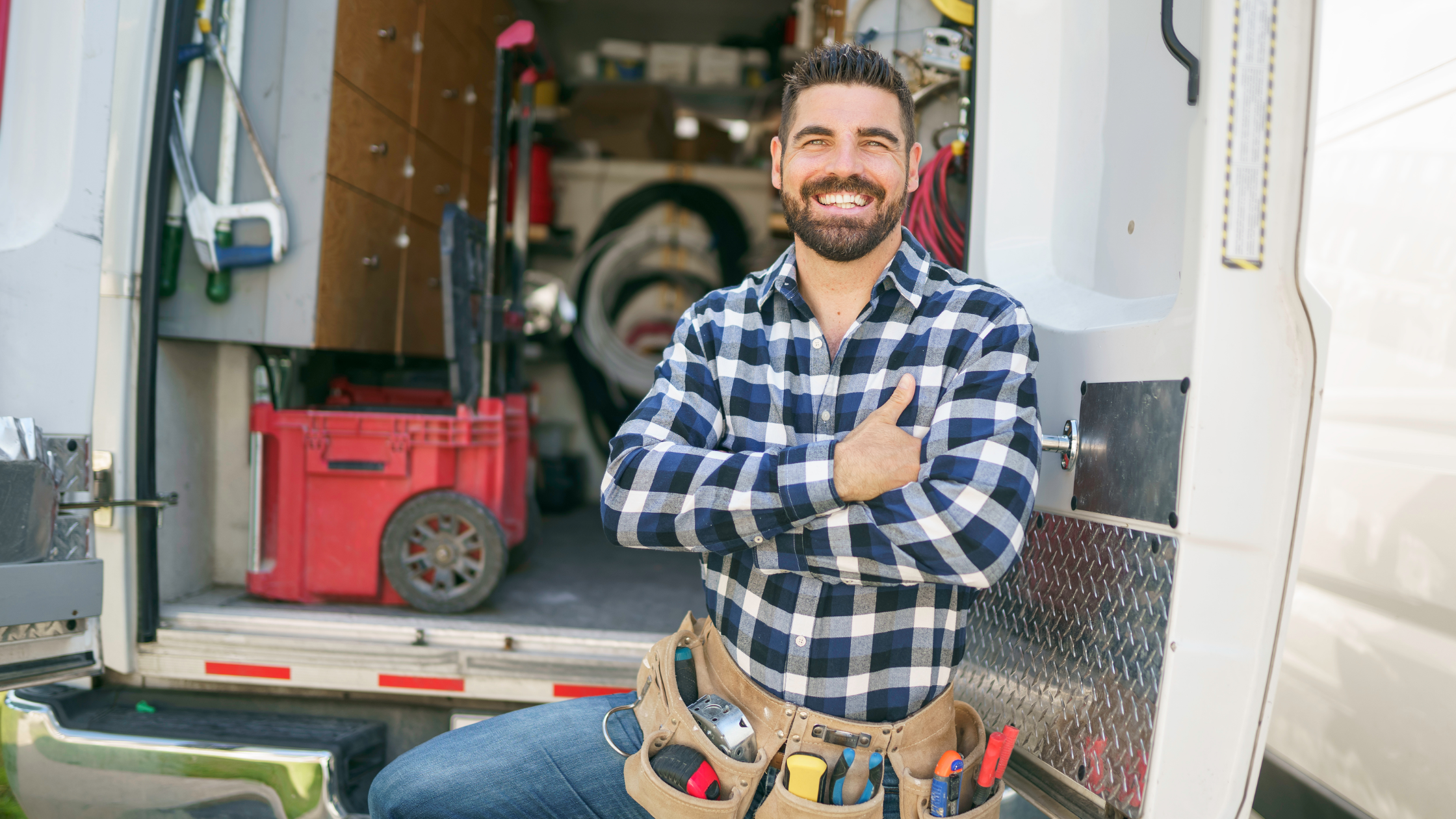 Smiling electrician outside van